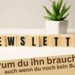 Das Wort Autoren-Newsletter steht vor einer Pflanze auf einem Tisch.